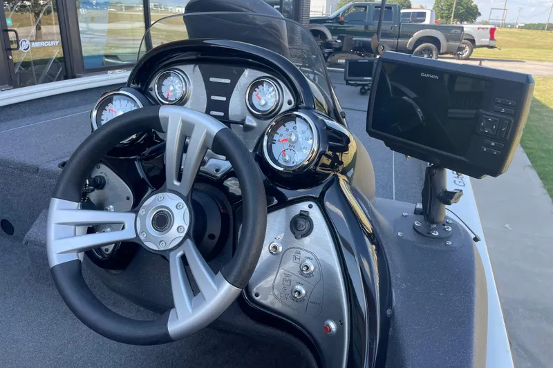 Slide: The Image of 2021 Bass Tracker PT175 boat dashboard with steering wheel and Garmin display. - 8