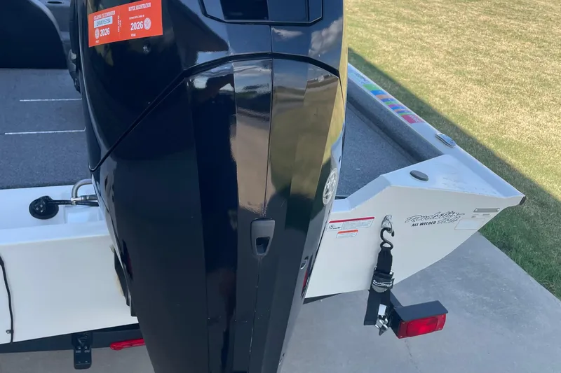 Slide: The Image of 2021 Bass Tracker PT175 boat with motor and trailer, parked on concrete. - 9