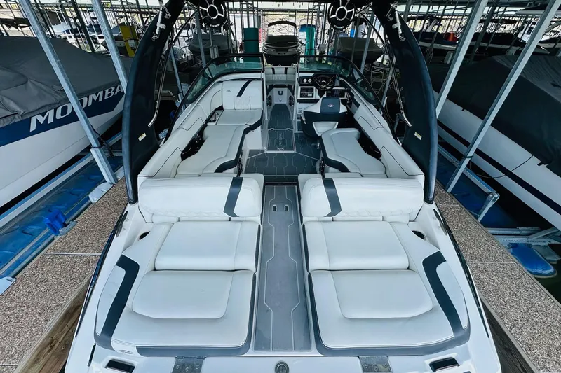 Slide: The Image of 2018 Regal 2300 Bowrider with spacious seating, docked in a marina. - 13