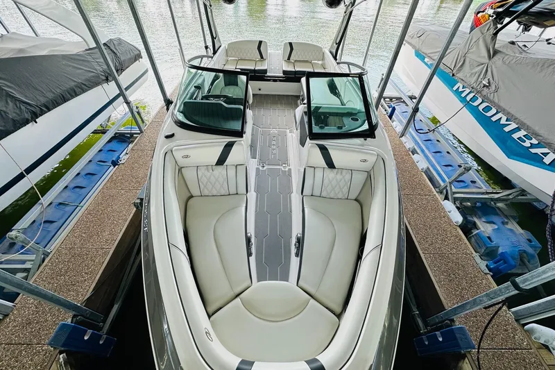 Slide: The Image of 2018 Regal 2300 Bowrider boat docked, featuring spacious seating and sleek design. - 16