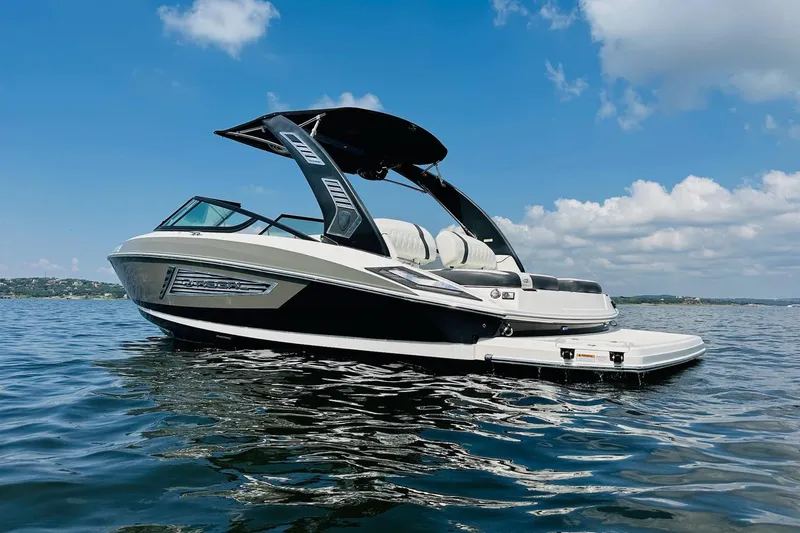 Slide: The Image of 2018 Regal 2300 Bowrider on calm water under blue sky. - 7