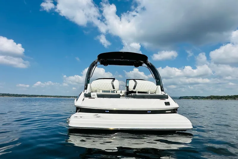 Slide: The Image of 2018 Regal 2300 Bowrider on calm water under a blue sky with clouds. - 8