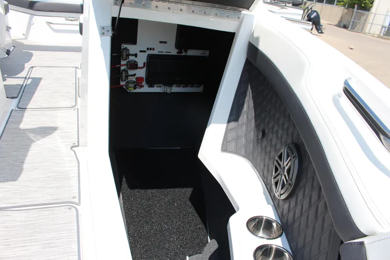 Slide: The Image of 2025 Cobalt R4 boat interior with speaker, cup holders, and electrical panel. - 11