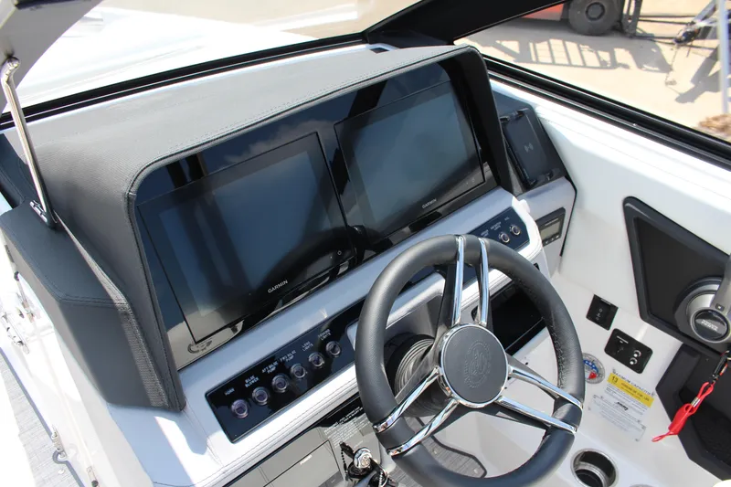 Slide: The Image of 2025 Cobalt R4 boat dashboard with dual Garmin displays and modern steering wheel. - 15