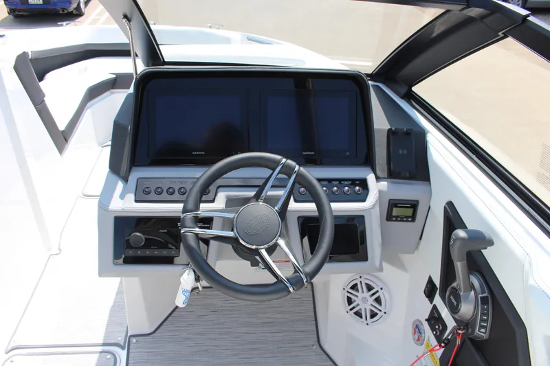 Slide: The Image of 2025 Cobalt R4 boat dashboard with steering wheel, dual screens, and control panel. - 16