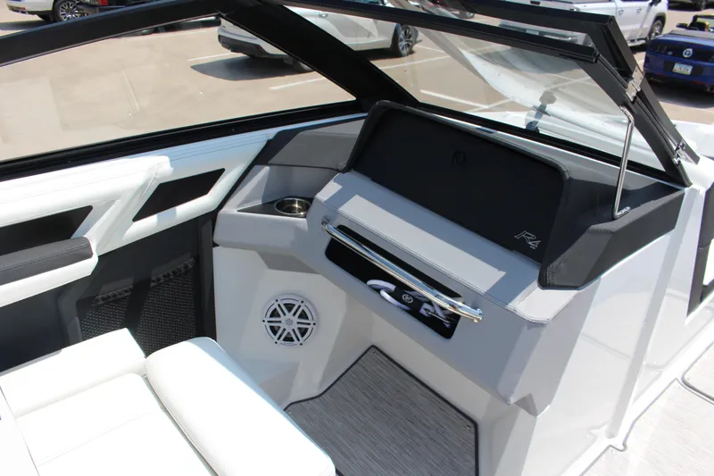 Slide: The Image of 2025 Cobalt R4 boat interior with sleek design, featuring white seating and modern dashboard. - 17