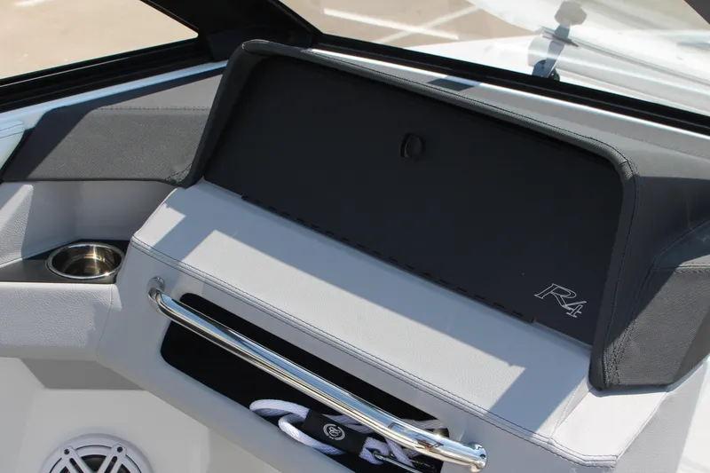 Slide: The Image of 2025 Cobalt R4 boat interior with cup holder and storage compartment. - 18