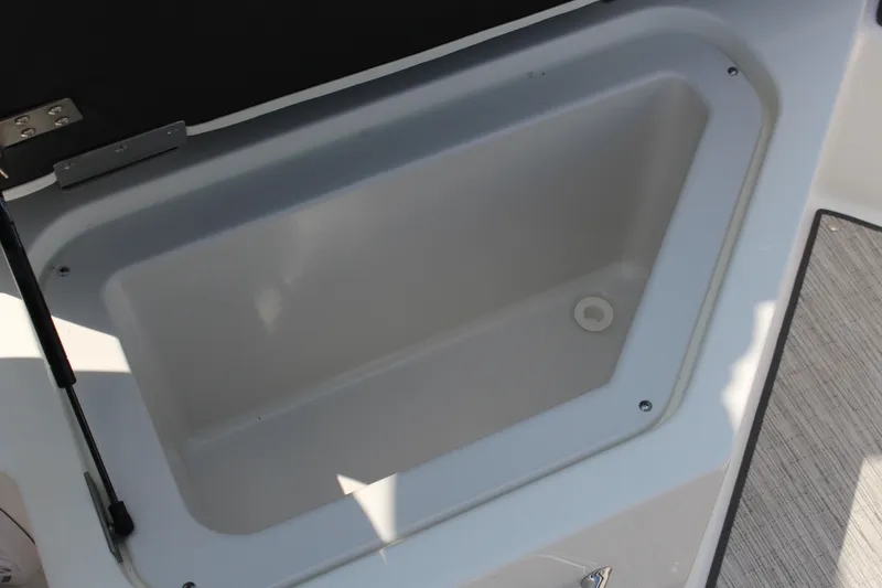 Slide: The Image of Cobalt R4 2025 boat storage compartment with open lid, showcasing interior space. - 20