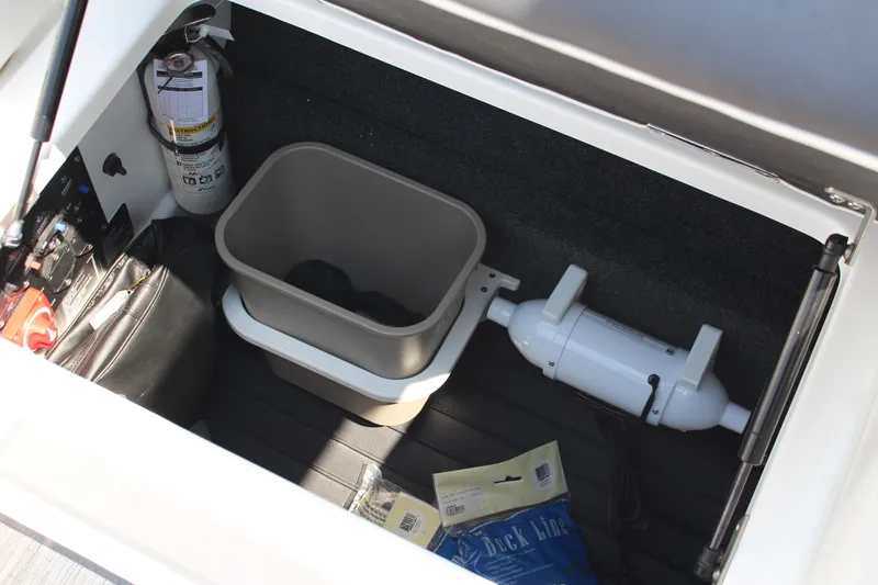 Slide: The Image of Storage compartment in 2025 Cobalt R4 boat with fire extinguisher and accessories. - 21