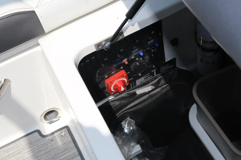 Slide: The Image of Control panel of 2025 Cobalt R4 boat with red switch and storage compartment. - 22