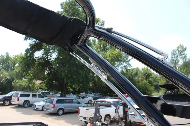 Slide: The Image of 2025 Cobalt R4 boat with sleek black frame and chrome accents in a parking lot. - 26