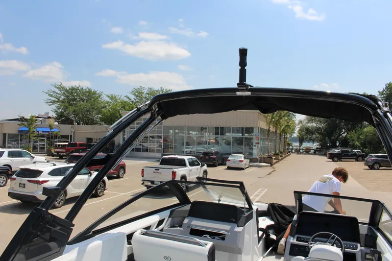 Slide: The Image of 2025 Cobalt R4 boat in parking lot, surrounded by cars and dealership. - 28