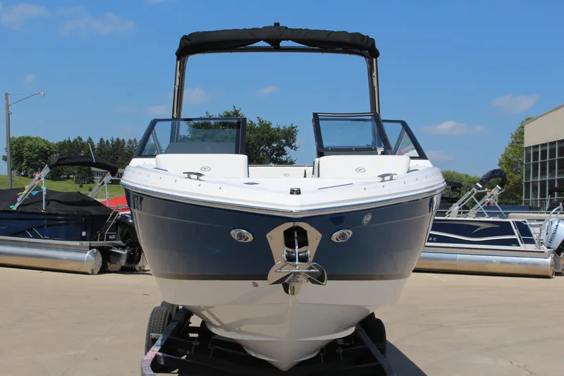 Slide: The Image of 2025 Cobalt R4 boat on trailer, displayed outdoors under clear blue sky. - 31