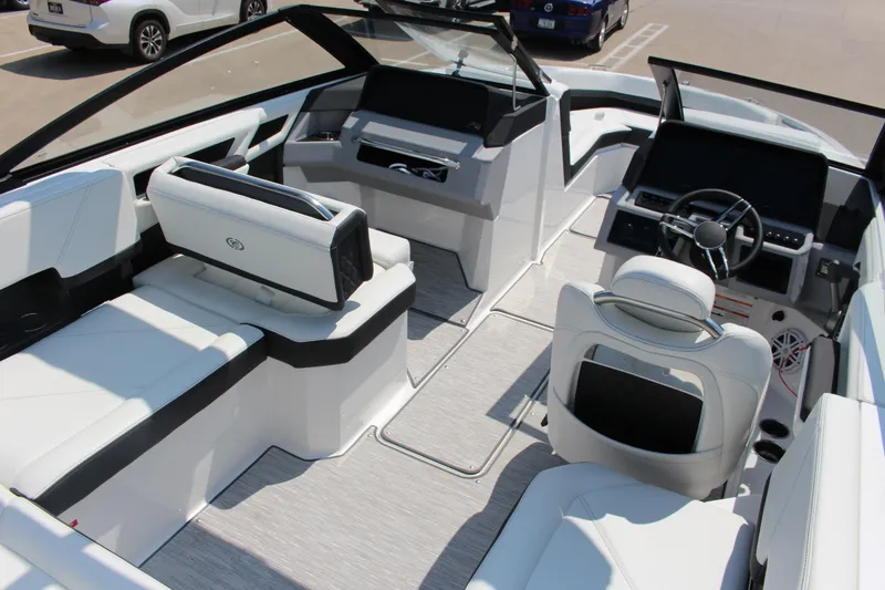 Slide: The Image of 2025 Cobalt R4 boat interior with sleek white seating and modern dashboard design. - 7