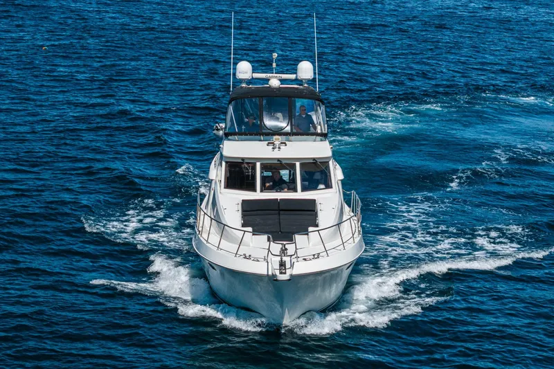 Slide: The Image of 2002 McKinna 57 Pilothouse yacht cruising on open blue waters. - 10
