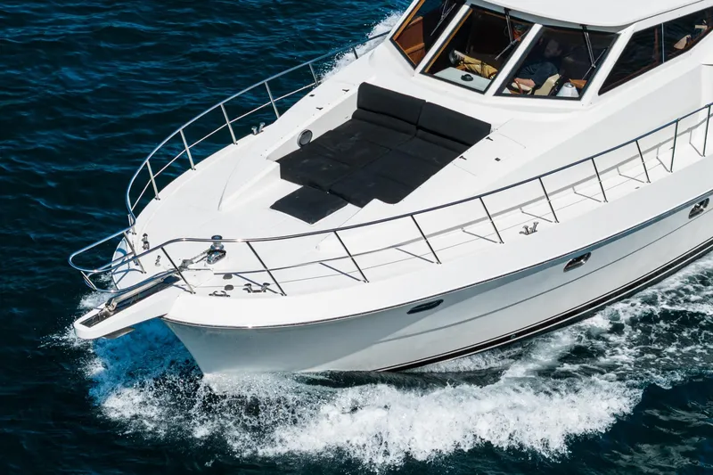 Slide: The Image of 2002 McKinna 57 Pilothouse yacht cruising on blue ocean waters. - 11