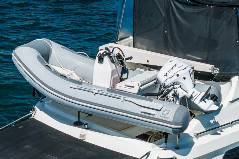 Slide: The Image of Inflatable Zodiac boat with Tohatsu motor on 2002 McKinna 57 Pilothouse yacht. - 13
