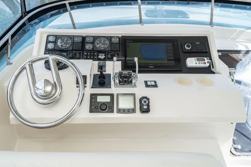 Slide: The Image of Control panel of a 2002 McKinna 57 Pilothouse yacht with steering wheel and navigation instruments. - 16