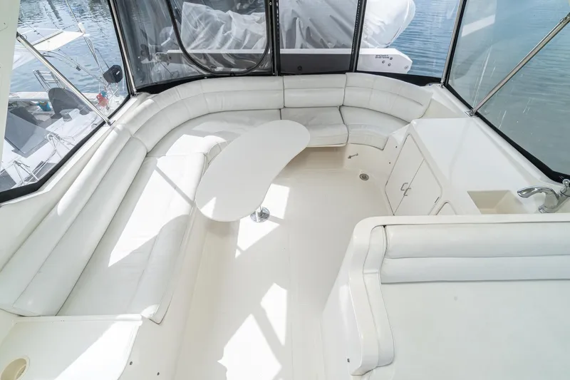 Slide: The Image of Luxurious interior of 2002 McKinna 57 Pilothouse yacht with white seating and table. - 19