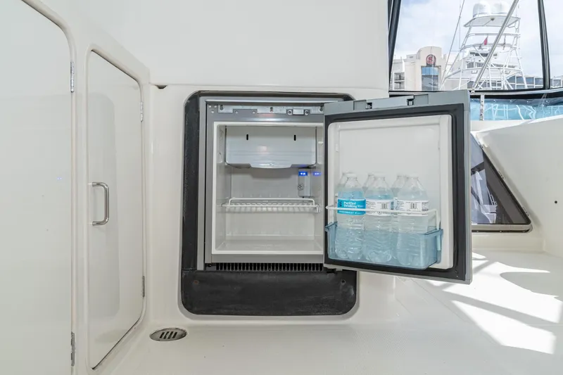 Slide: The Image of Open mini fridge with water bottles on a 2002 McKinna 57 Pilothouse yacht. - 23
