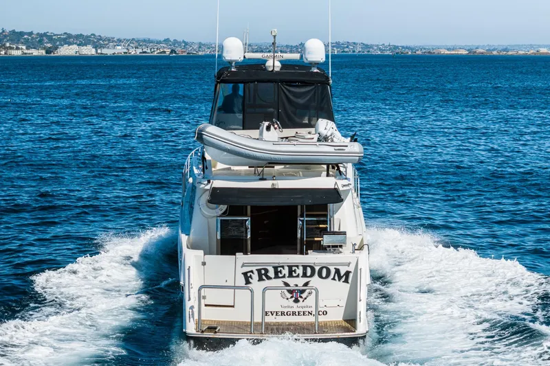 Slide: The Image of 2002 McKinna 57 Pilothouse yacht cruising on open water, rear view. - 24