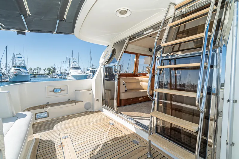 Slide: The Image of Luxurious 2002 McKinna 57 Pilothouse yacht interior with wooden deck and marina view. - 29