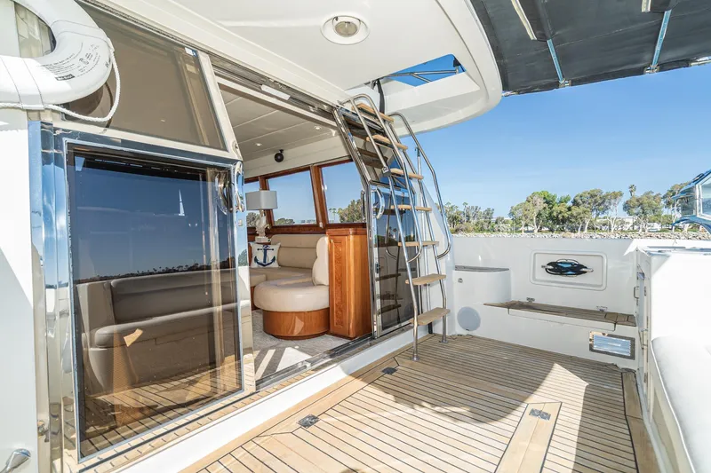 Slide: The Image of 2002 McKinna 57 Pilothouse yacht interior with wooden deck and seating area. - 30