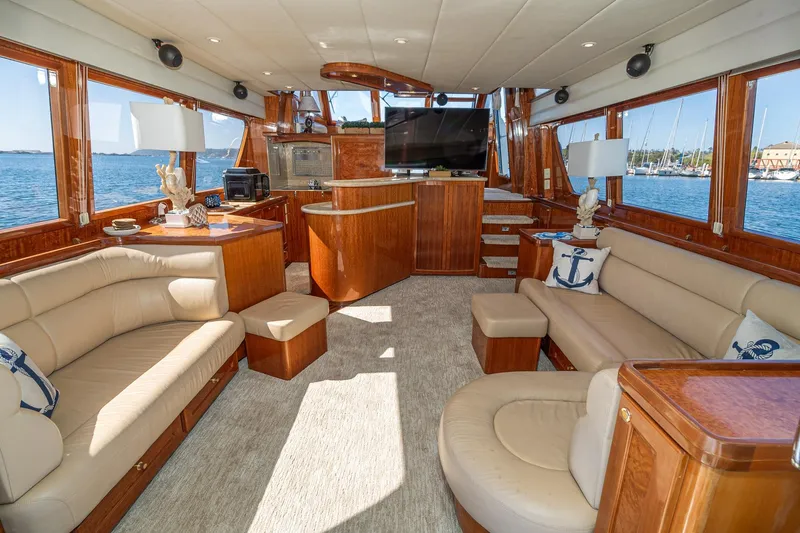 Slide: The Image of Luxurious interior of 2002 McKinna 57 Pilothouse yacht with elegant wood finishes and plush seating. - 32