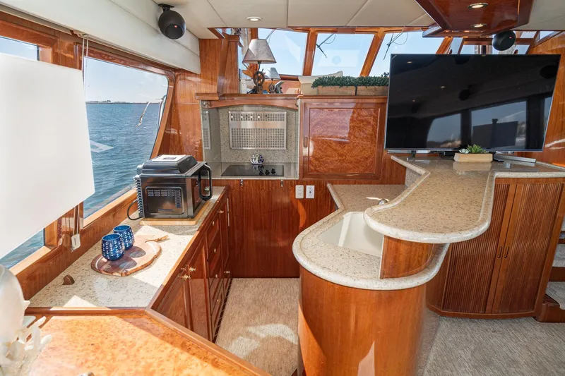 Slide: The Image of Luxurious interior of 2002 McKinna 57 Pilothouse yacht with modern kitchen and entertainment area. - 38