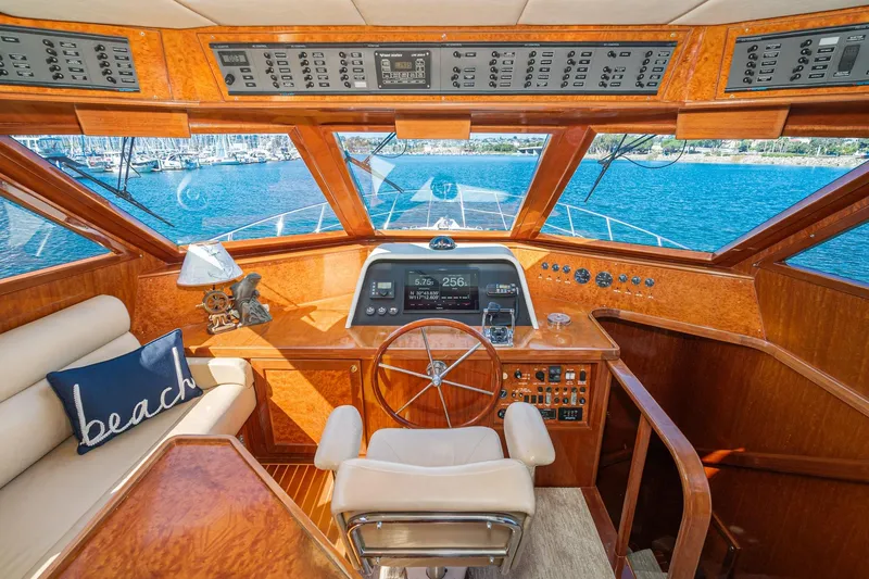 Slide: The Image of Pilothouse interior of 2002 McKinna 57 yacht with wooden finish and navigation controls. - 44
