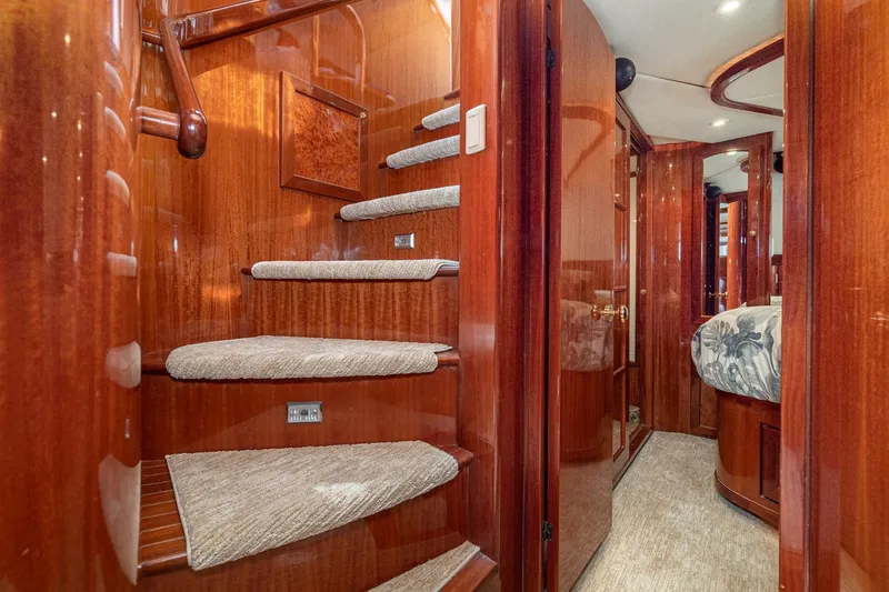 Slide: The Image of Luxurious interior of 2002 McKinna 57 Pilothouse yacht with polished wood and carpeted stairs. - 46