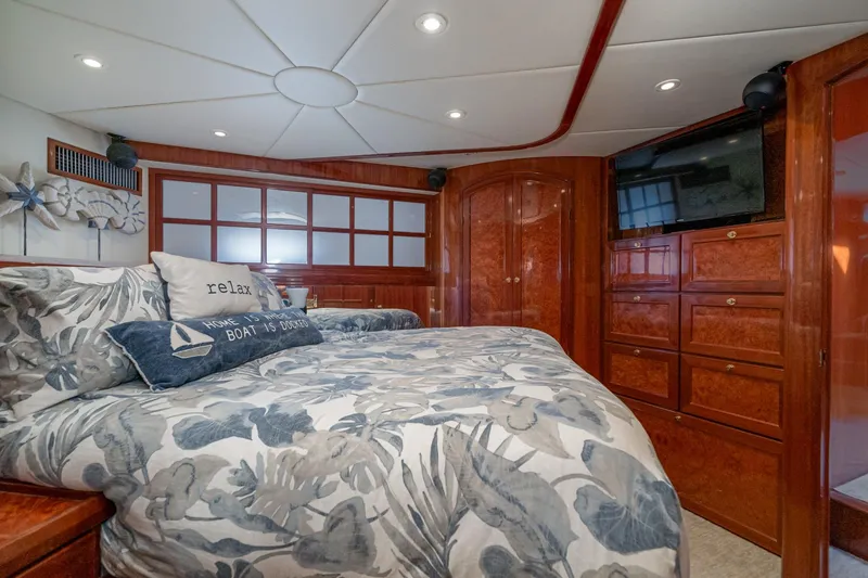 Slide: The Image of Luxurious 2002 McKinna 57 Pilothouse bedroom with elegant wood finishes and cozy bedding. - 48