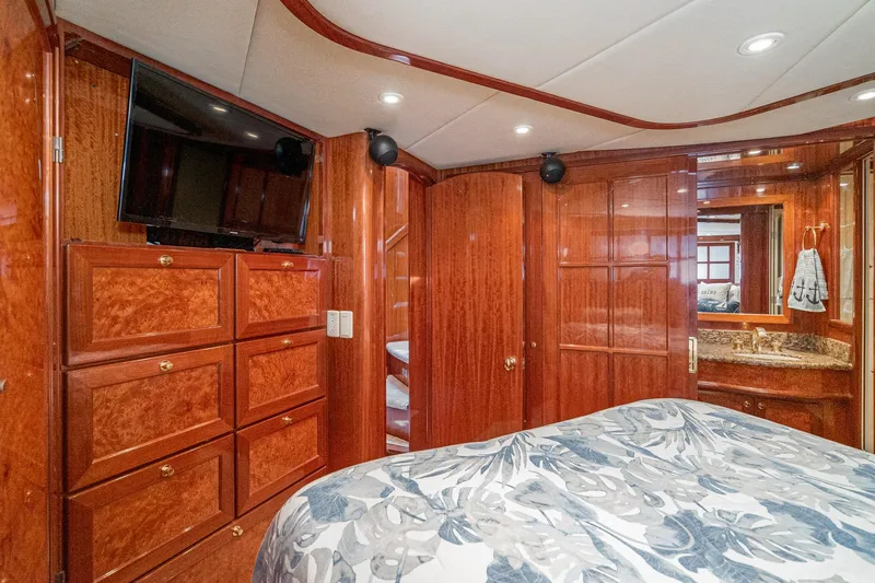 Slide: The Image of Luxurious 2002 McKinna 57 Pilothouse yacht bedroom with wood cabinetry and modern amenities. - 50