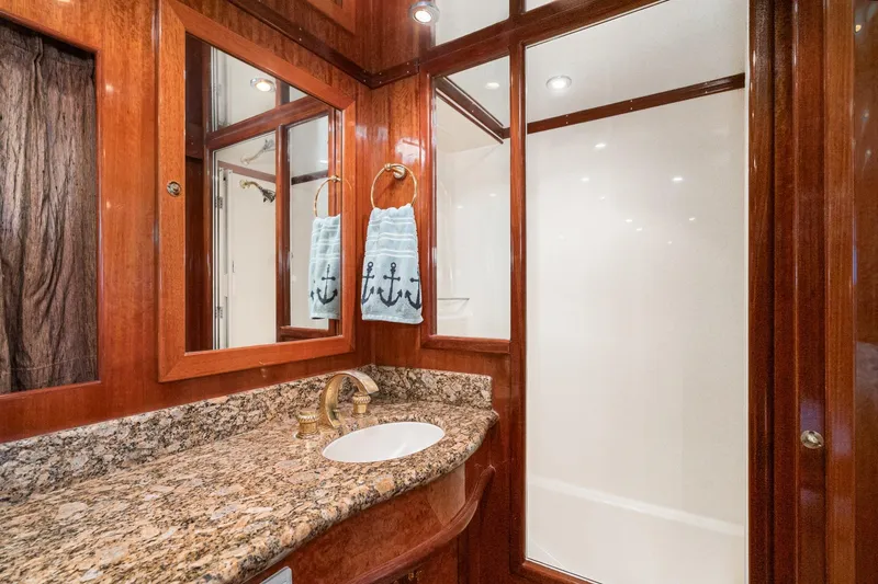 Slide: The Image of Luxurious bathroom in 2002 McKinna 57 Pilothouse yacht with granite countertop and wood accents. - 52