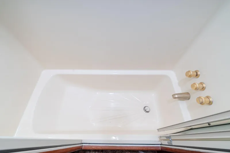 Slide: The Image of Luxurious bathtub with gold fixtures in 2002 McKinna 57 Pilothouse yacht. - 53