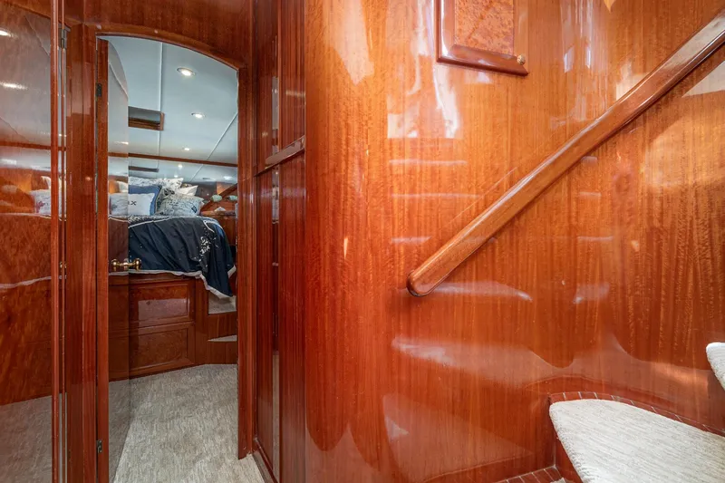 Slide: The Image of Luxurious interior of 2002 McKinna 57 Pilothouse yacht with polished wood and cozy bedroom. - 55