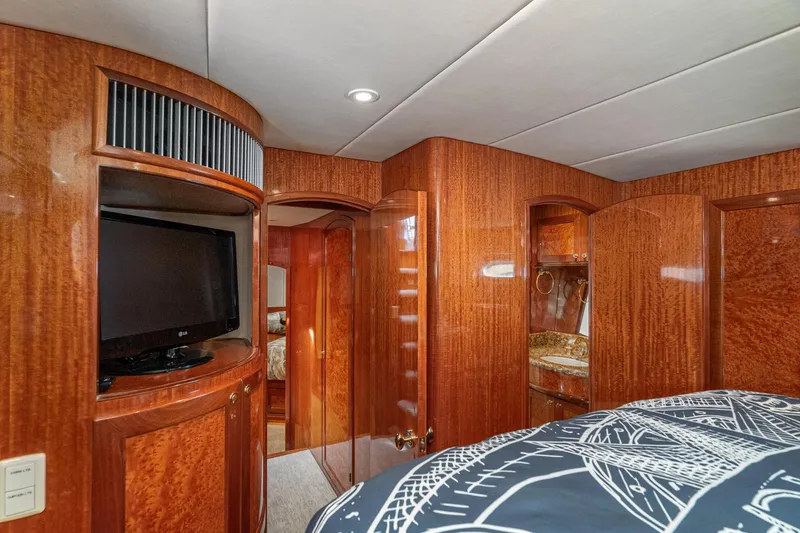 Slide: The Image of Luxurious interior of 2002 McKinna 57 Pilothouse yacht with wood paneling and TV. - 58