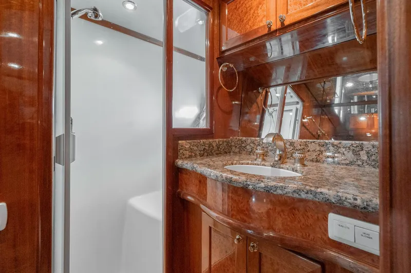 Slide: The Image of Luxurious bathroom in 2002 McKinna 57 Pilothouse yacht with granite countertop and wood cabinetry. - 59