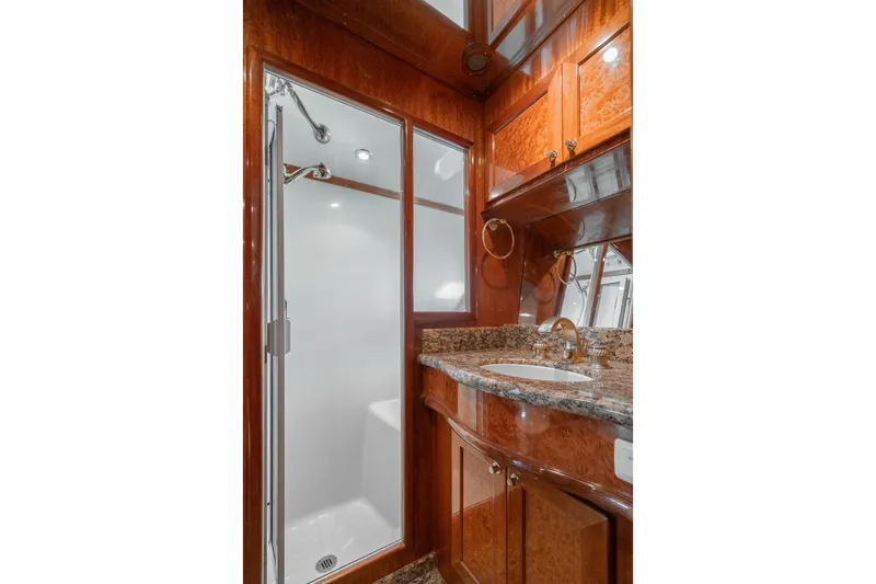 Slide: The Image of Luxurious bathroom in 2002 McKinna 57 Pilothouse yacht with granite countertop and enclosed shower. - 60