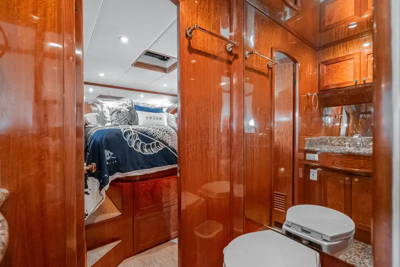 Slide: The Image of Luxurious 2002 McKinna 57 Pilothouse yacht interior with elegant wood finish and cozy bedroom. - 61
