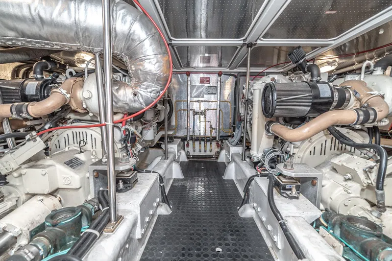 Slide: The Image of Engine room of 2002 McKinna 57 Pilothouse yacht, showcasing dual engines and mechanical systems. - 64