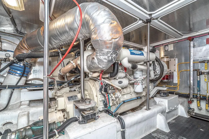 Slide: The Image of Engine room of a 2002 McKinna 57 Pilothouse yacht, showcasing mechanical components. - 65