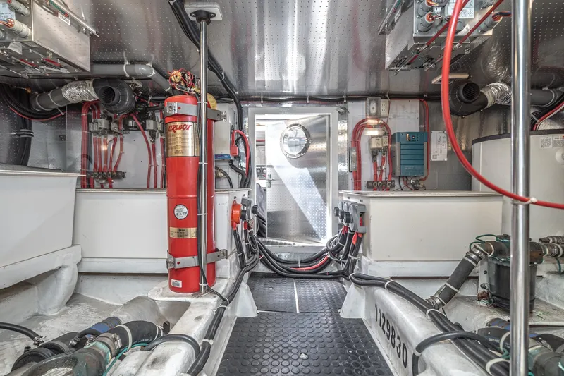 Slide: The Image of Engine room of 2002 McKinna 57 Pilothouse yacht, featuring equipment and wiring. - 69