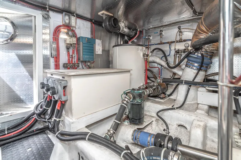 Slide: The Image of Engine room of 2002 McKinna 57 Pilothouse yacht with mechanical components and wiring. - 71