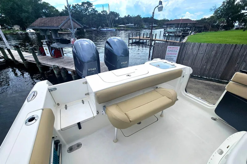 Slide: The Image of 2016 Sea Hunt Gamefish 25 boat with twin 150 engines docked by a marina. - 10