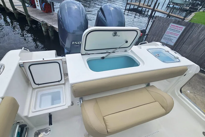 Slide: The Image of 2016 Sea Hunt Gamefish 25 boat with open storage compartments and twin Yamaha 150 engines. - 11