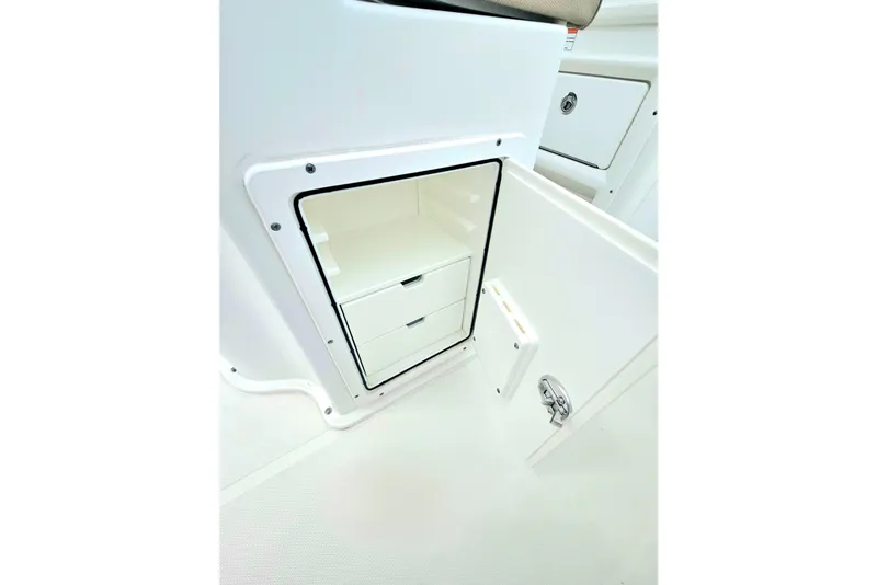 Slide: The Image of 2016 Sea Hunt Gamefish 25 storage compartment with drawers, showcasing sleek interior design. - 13