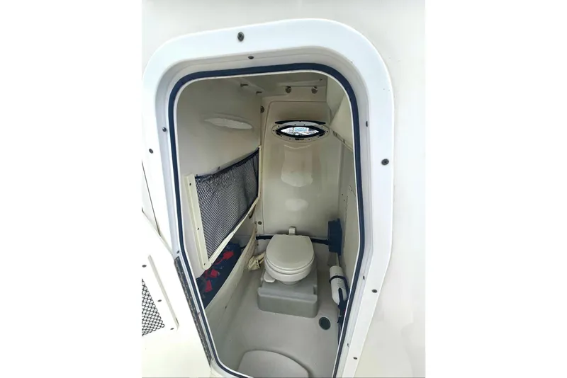 Slide: The Image of 2016 Sea Hunt Gamefish 25 boat interior with compact marine toilet. - 16