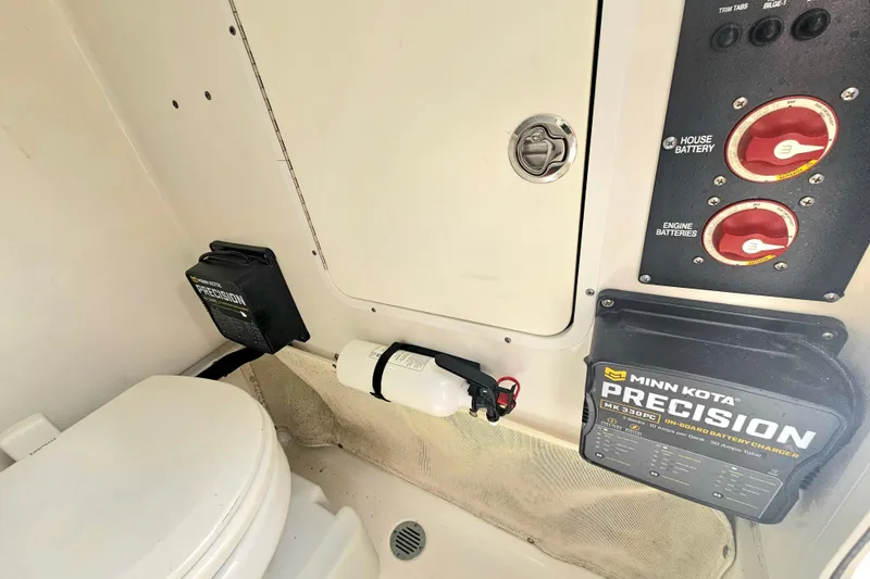 Slide: The Image of 2016 Sea Hunt Gamefish 25 interior with Minn Kota Precision charger and battery controls. - 17