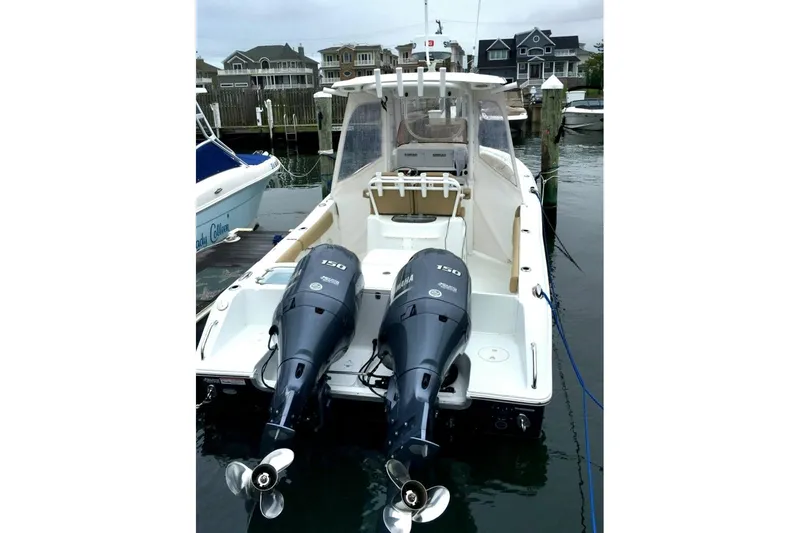 Slide: The Image of 2016 Sea Hunt Gamefish 25 with dual Yamaha engines docked at marina. - 22
